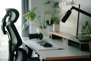 Siège de bureau réglable posé devant un poste de travail